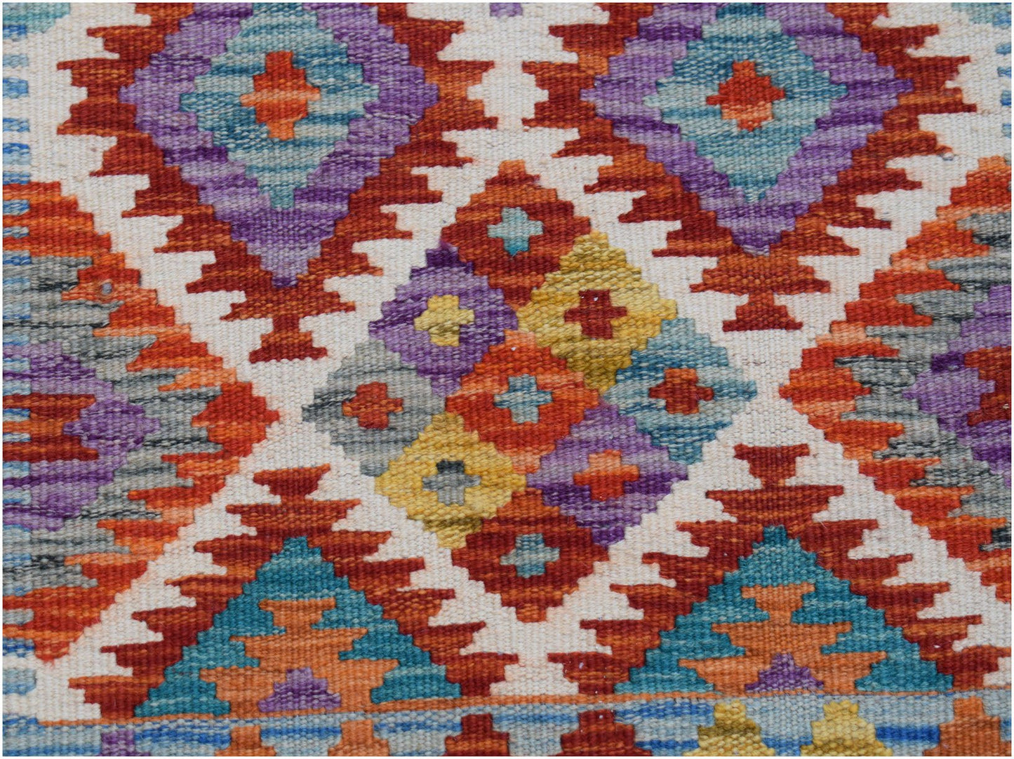 Handwoven Afghan Maimana wool runner featuring a colorful geometric diamond pattern.