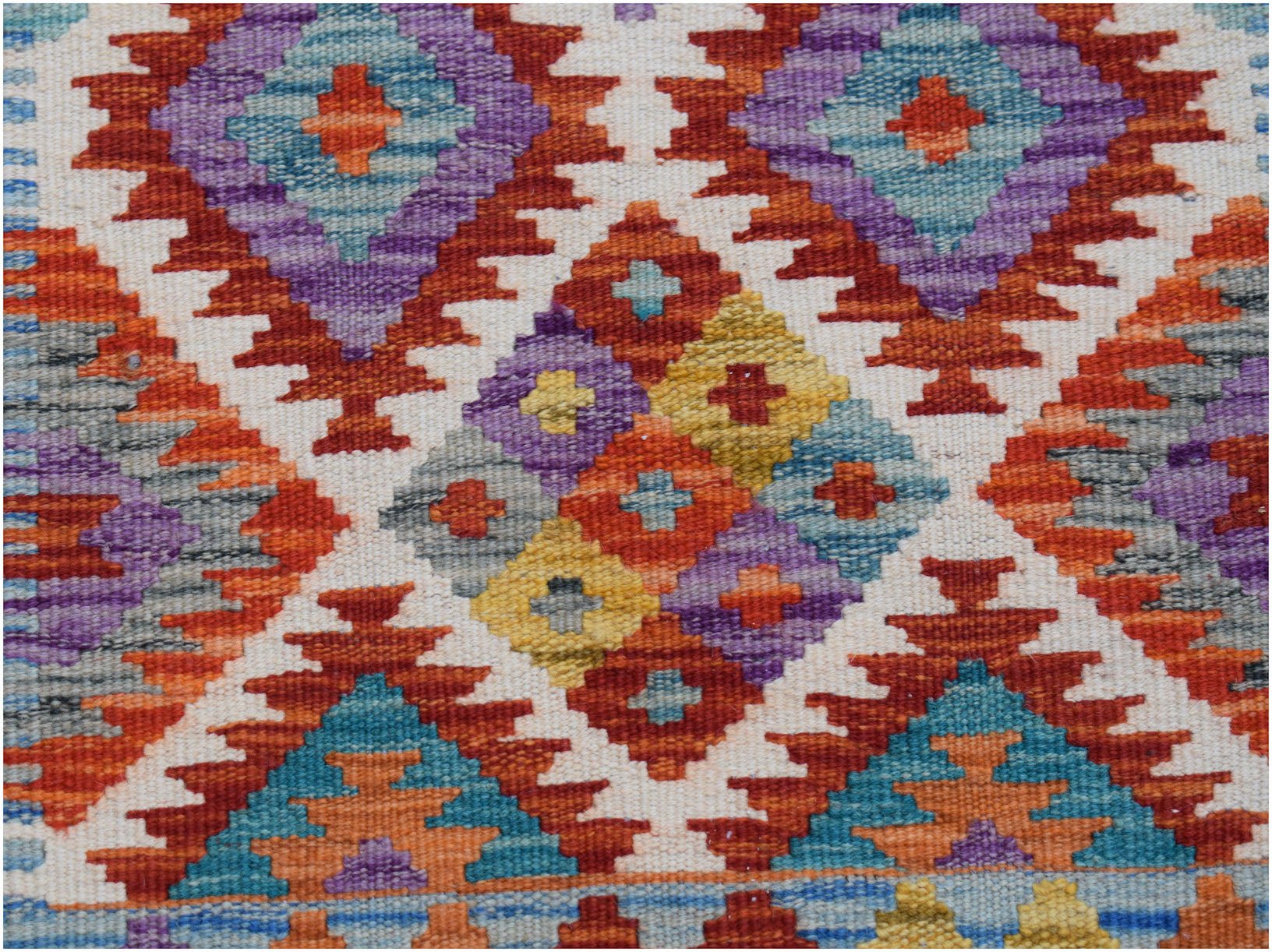 Handwoven Afghan Maimana wool runner featuring a colorful geometric diamond pattern.