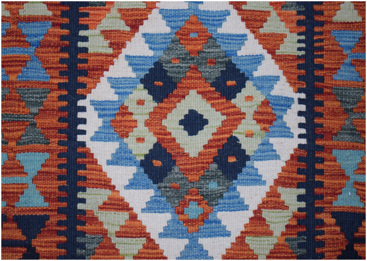 Handwoven Afghan Maimana wool runner featuring a geometric diamond pattern in vibrant colors.
