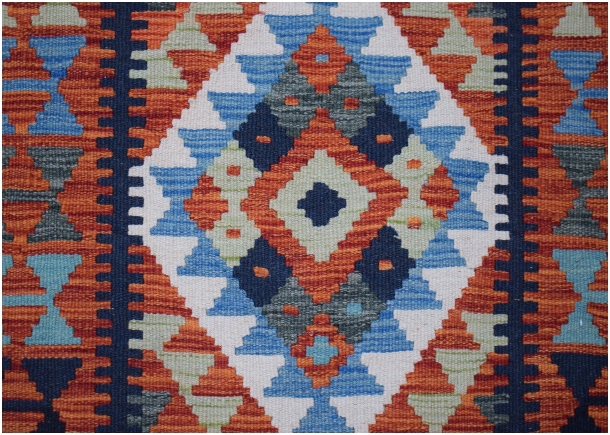 Handwoven Afghan Maimana wool runner featuring a geometric diamond pattern in vibrant colors.