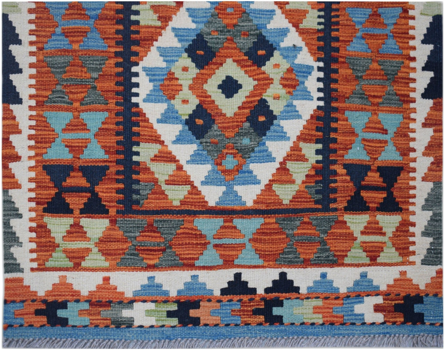 Handwoven Afghan Maimana wool runner featuring a geometric diamond pattern in vibrant colors.