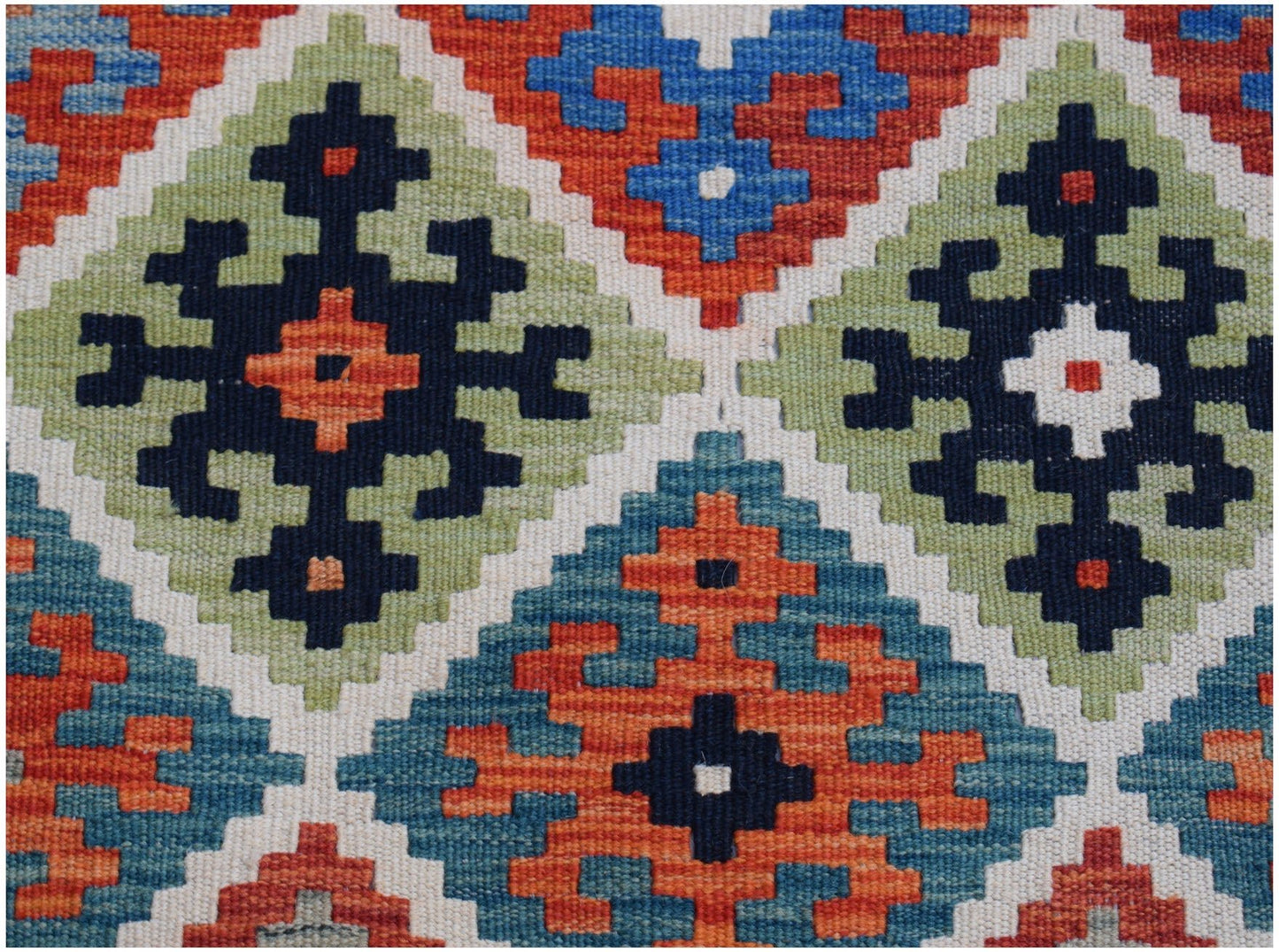 Handwoven Afghan Maimana kilim runner featuring a geometric pattern in blue, orange, and green.