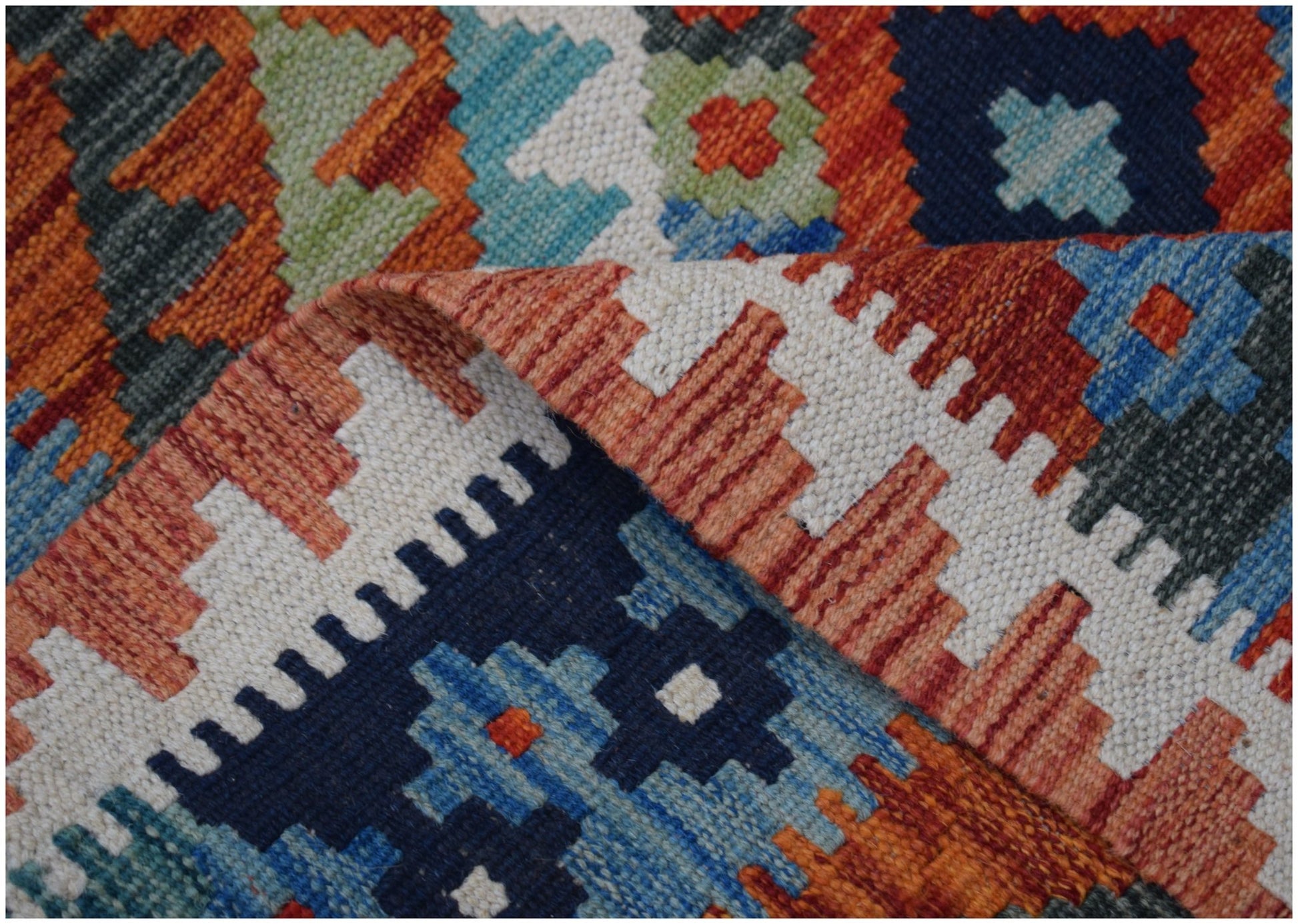 Handwoven Afghan Maimana kilim runner featuring a geometric pattern in vibrant wool colors.