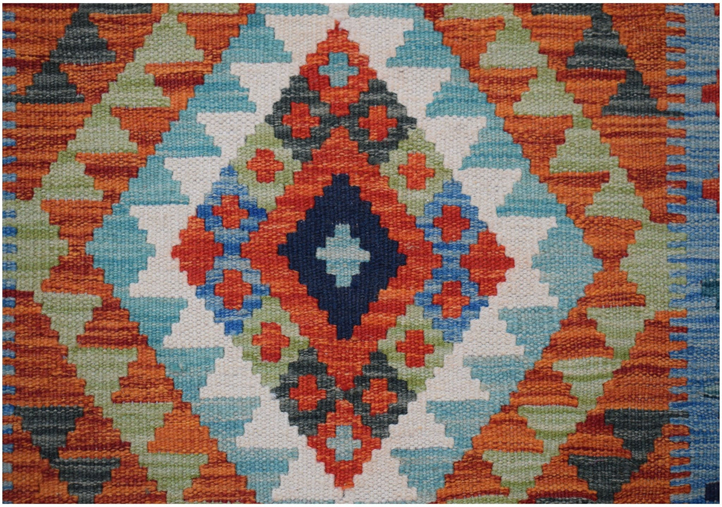 Handwoven Afghan Maimana kilim runner featuring a vibrant geometric diamond pattern in wool.