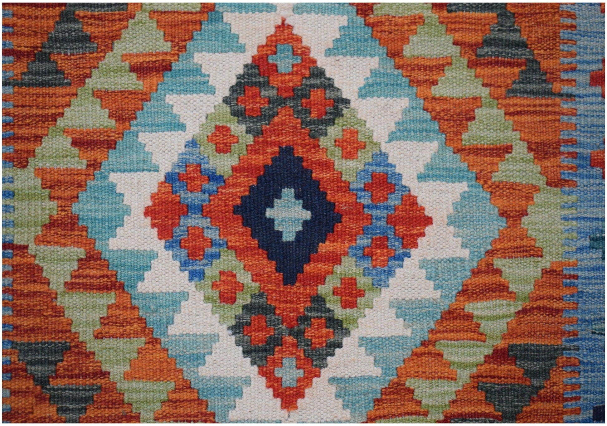 Handwoven Afghan Maimana kilim runner featuring a vibrant geometric diamond pattern in wool.