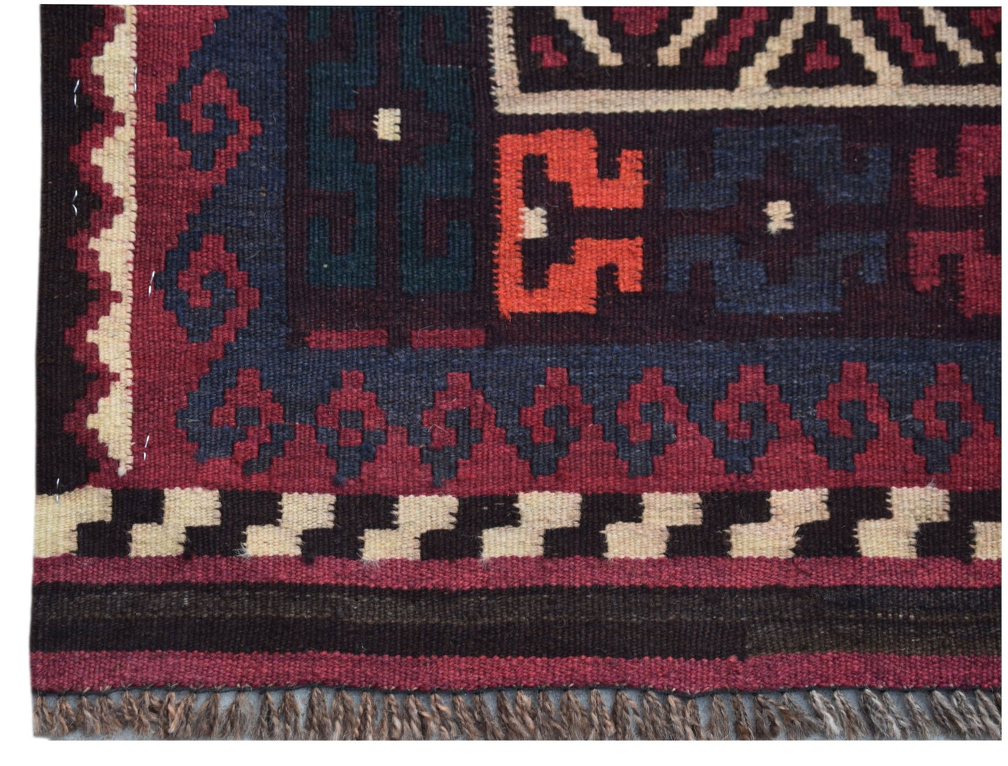 Handwoven Afghan Maimana kilim runner featuring geometric patterns in red, blue, and cream wool.