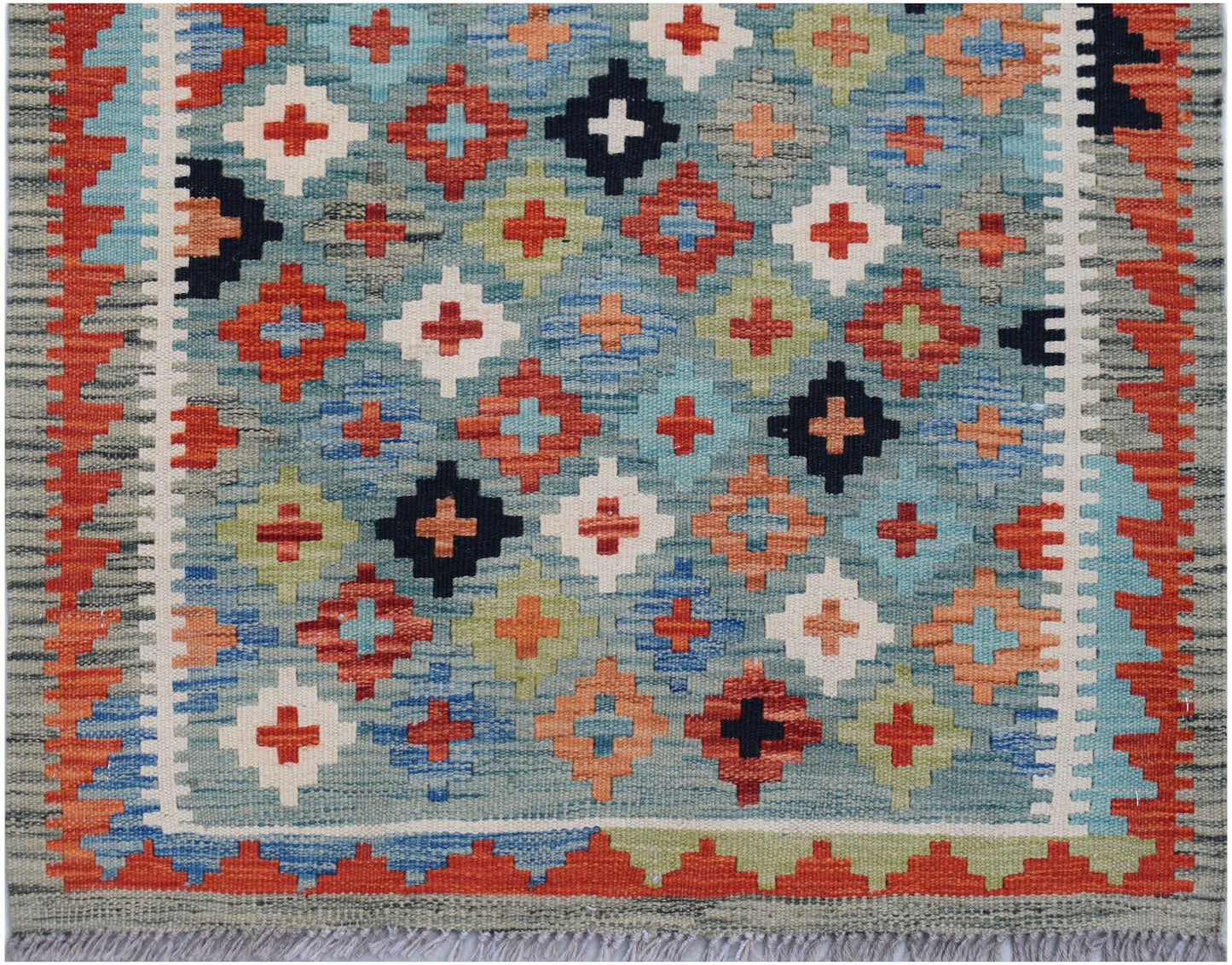 Handwoven Afghan Maimana wool runner featuring a colorful geometric pattern on a blue background.