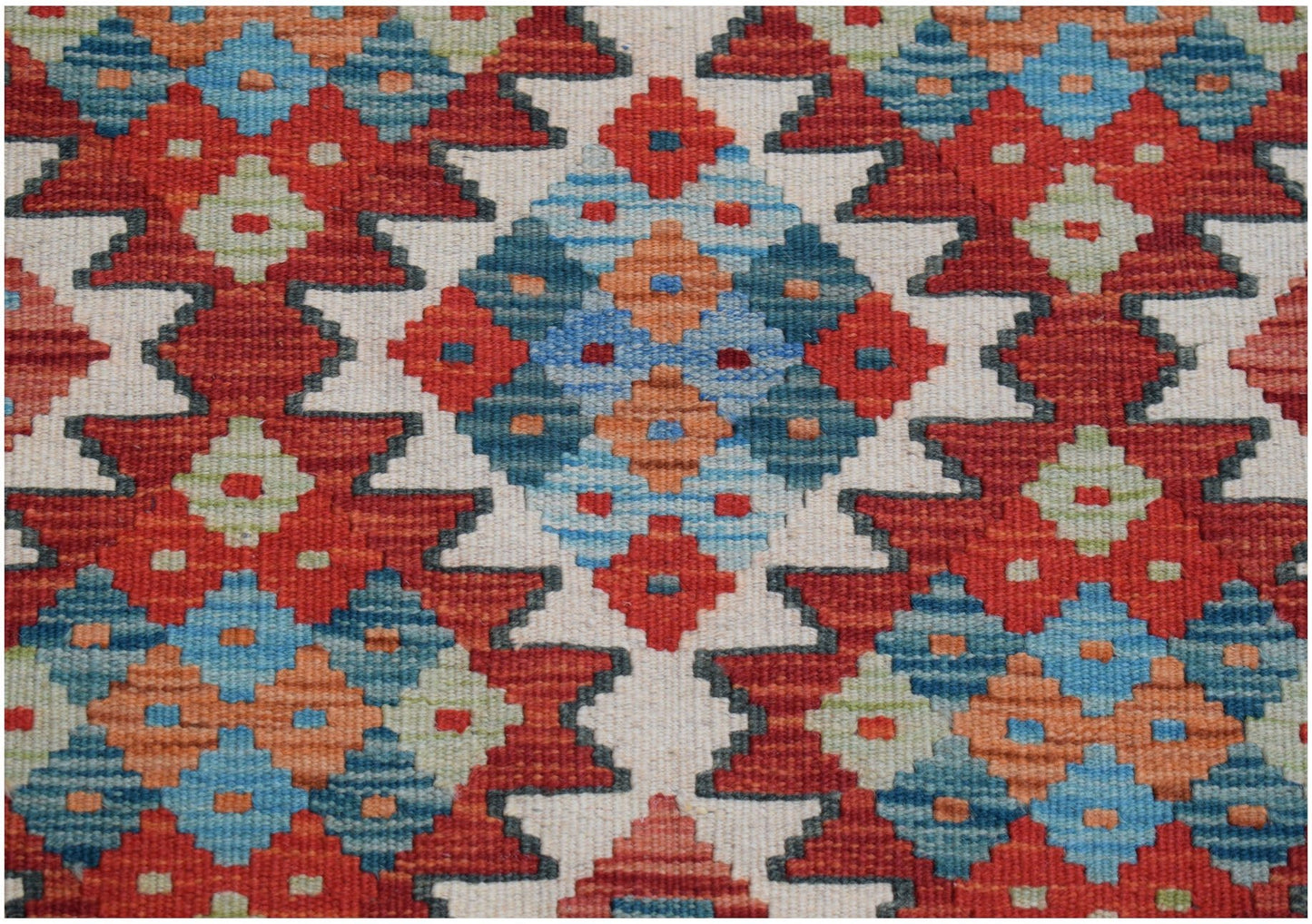Handwoven Afghan Maimana kilim runner featuring a geometric pattern in red, blue, and orange.
