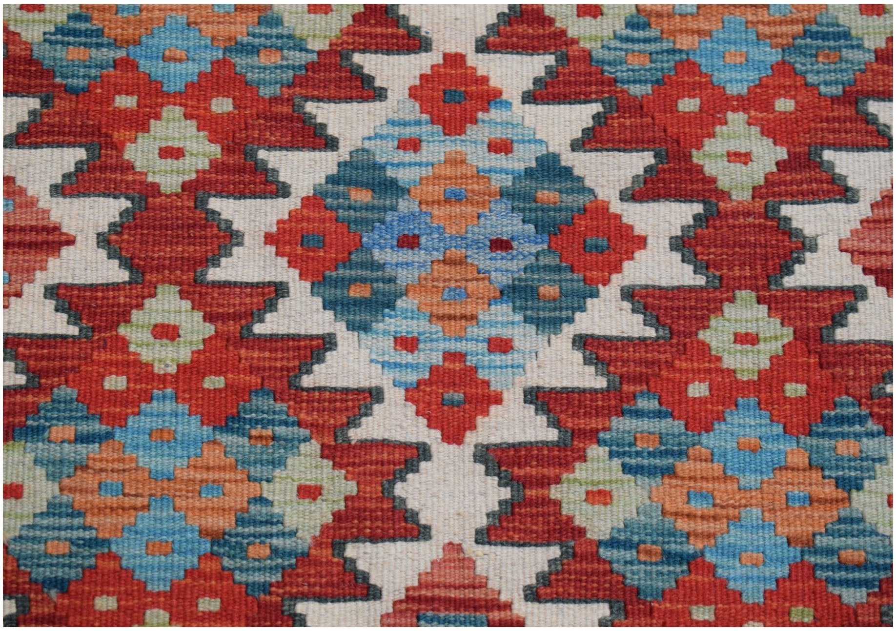 Handwoven Afghan Maimana kilim runner featuring a geometric pattern in red, blue, and orange.