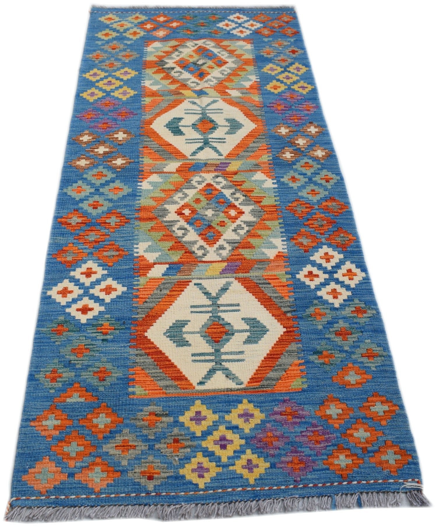 Handwoven Afghan Maimana wool runner rug featuring a blue background and geometric patterns.
