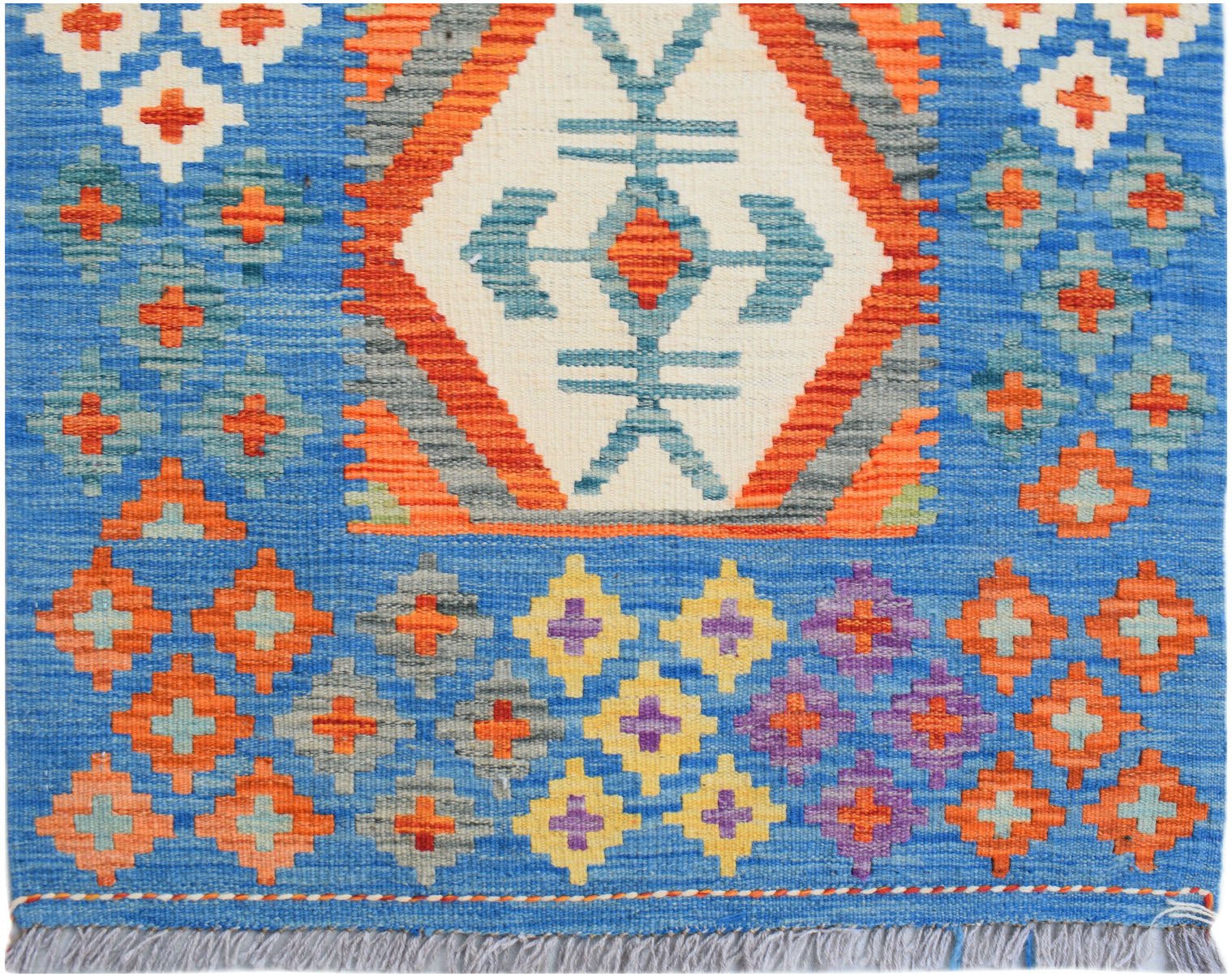 Handwoven Afghan Maimana wool runner featuring a blue background with geometric patterns.