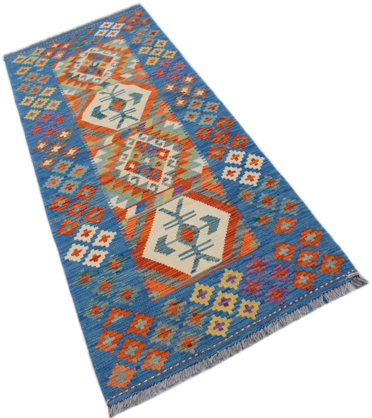 A handmade Afghan Maimana wool runner rug featuring geometric patterns in blue, orange, and white.