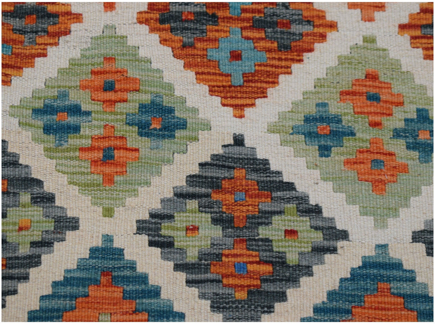Handwoven Afghan Maimana kilim runner featuring a geometric diamond pattern in vibrant colors.