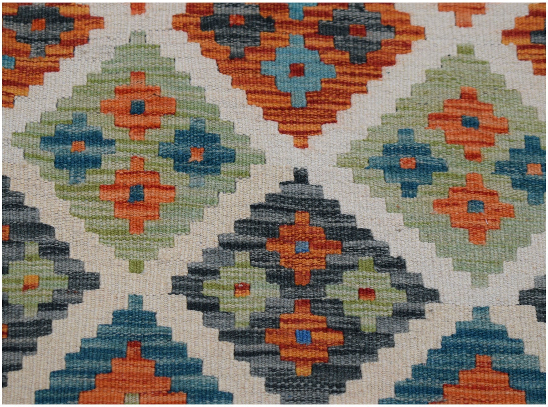 Handwoven Afghan Maimana kilim runner featuring a geometric diamond pattern in vibrant colors.