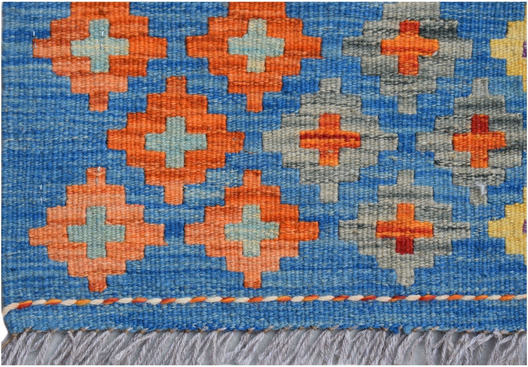 Handwoven Afghan Maimana kilim runner featuring a blue field with geometric orange and grey motifs.