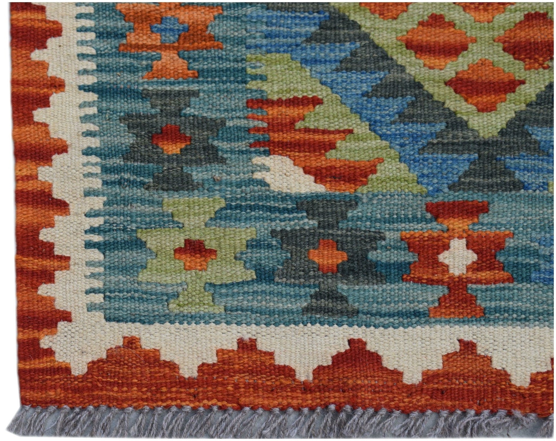 A handmade Afghan Maimana kilim runner featuring geometric patterns in blue, orange, and green.