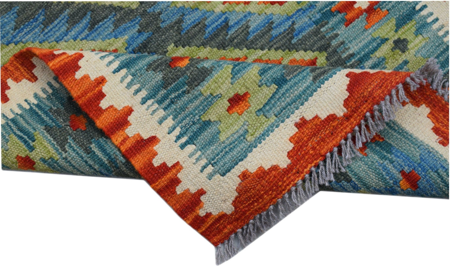 A handmade Afghan Maimana wool kilim runner featuring a vibrant geometric pattern and fringe.