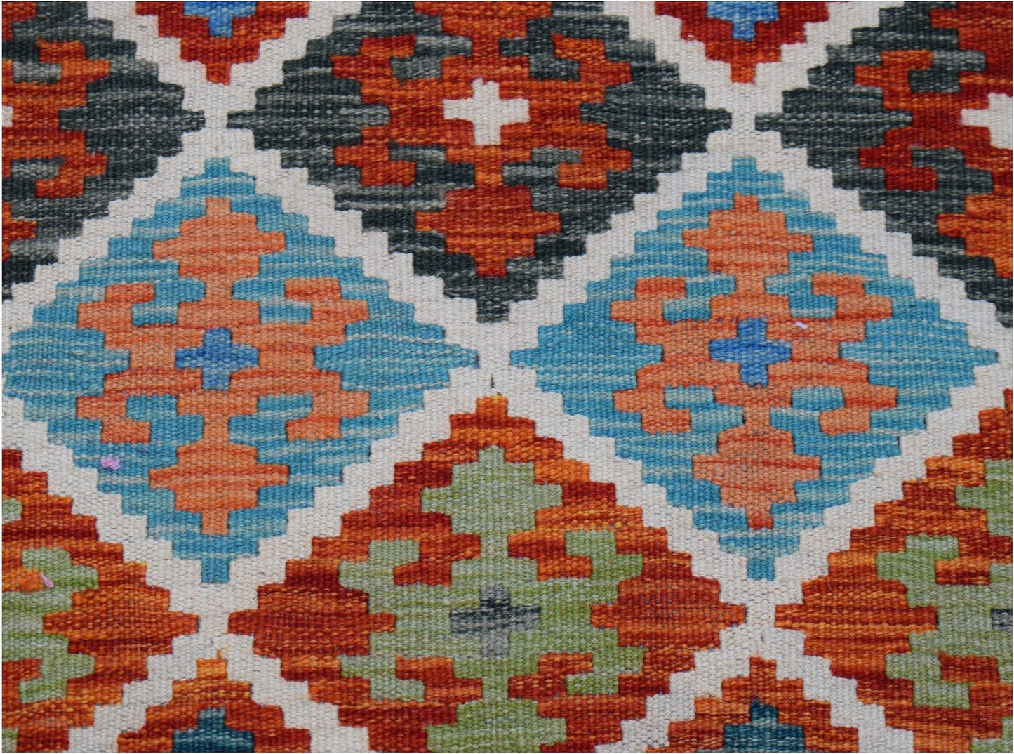 Handwoven Afghan Maimana kilim runner featuring a geometric diamond pattern in vibrant colors.
