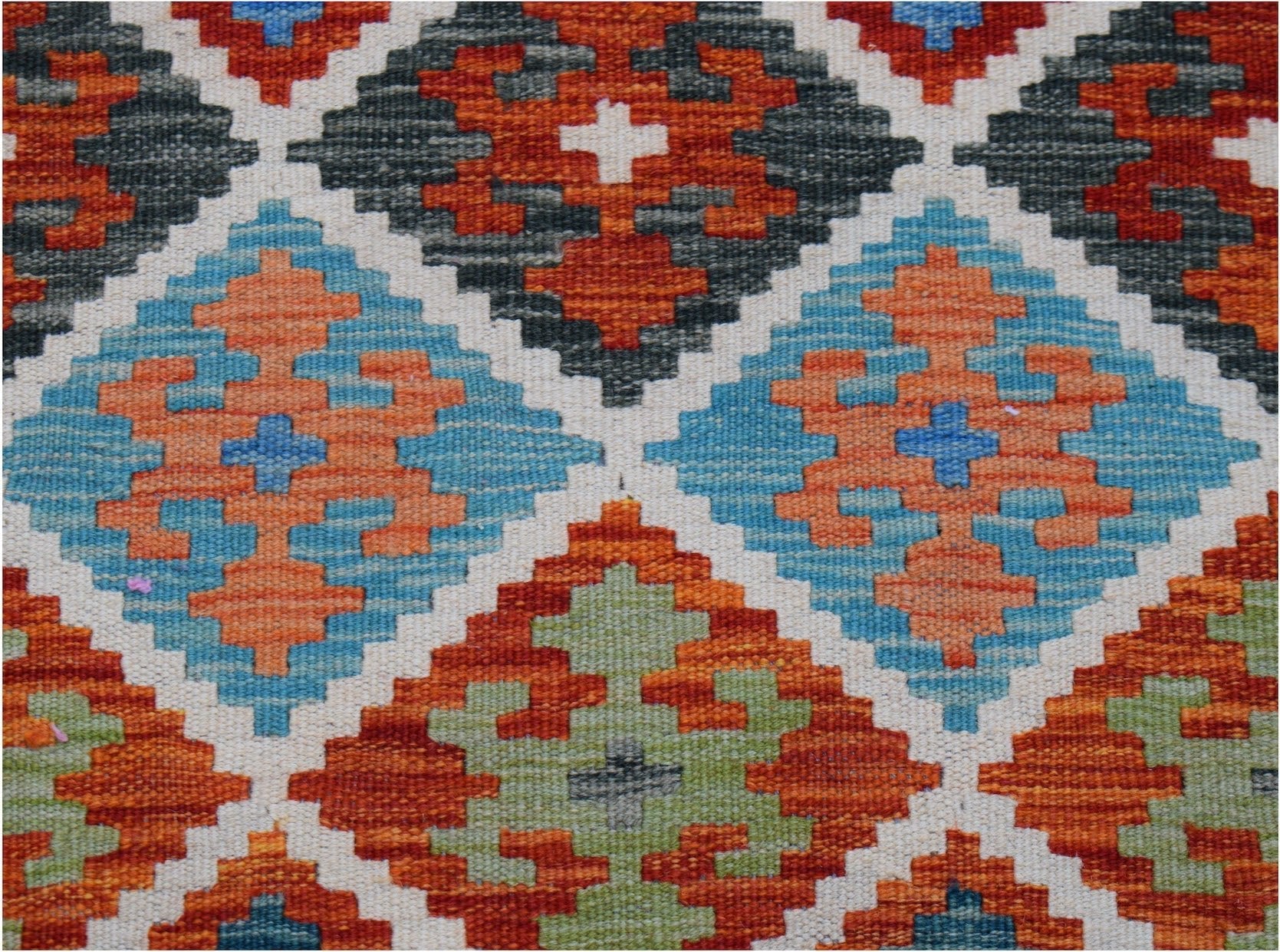 Handwoven Afghan Maimana kilim runner featuring a geometric diamond pattern in vibrant colors.