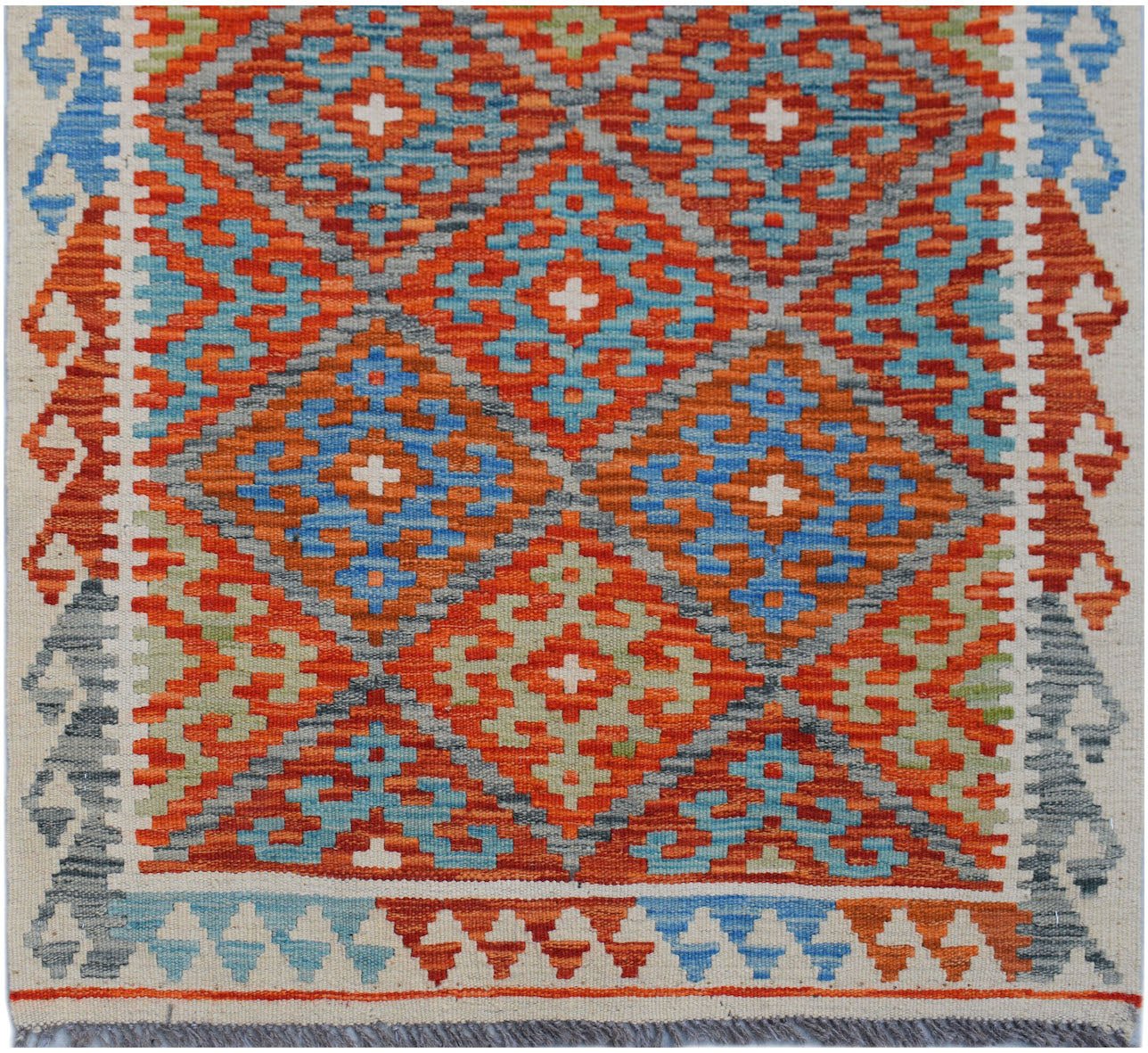 Handwoven Afghan Maimana wool runner featuring a geometric diamond pattern in vibrant colors.