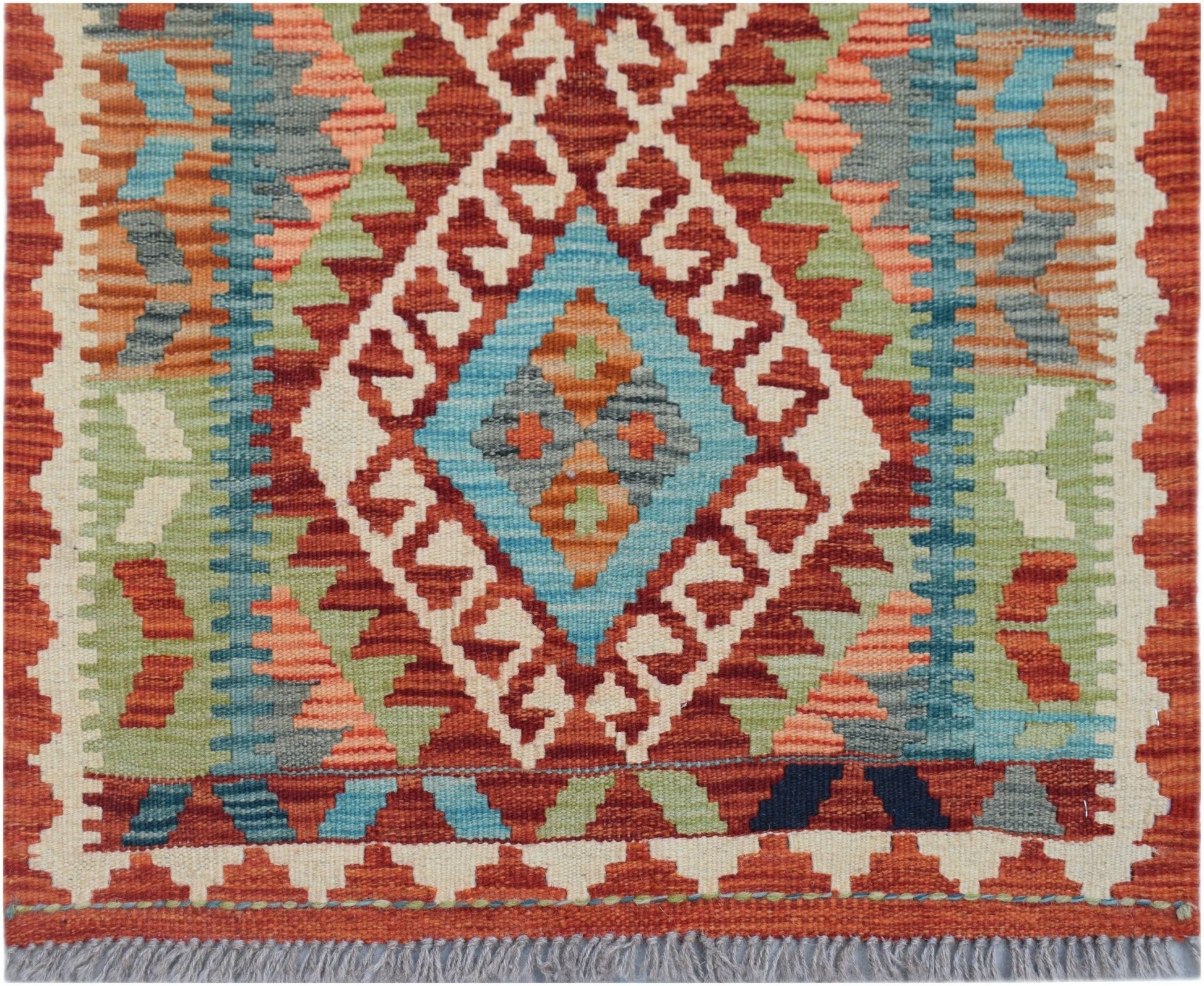 Handwoven Afghan Maimana kilim runner featuring a geometric diamond pattern in vibrant wool colors.