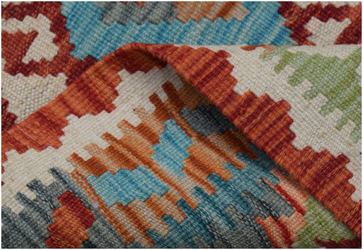 A handwoven Afghan Maimana kilim runner featuring a geometric pattern in vibrant wool colors.