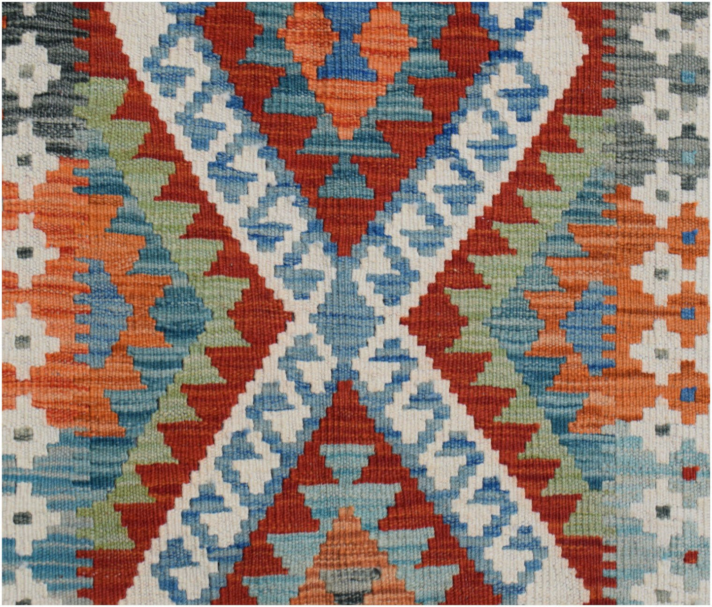Handwoven Afghan Maimana kilim runner featuring a geometric pattern in red, blue, and green wool.