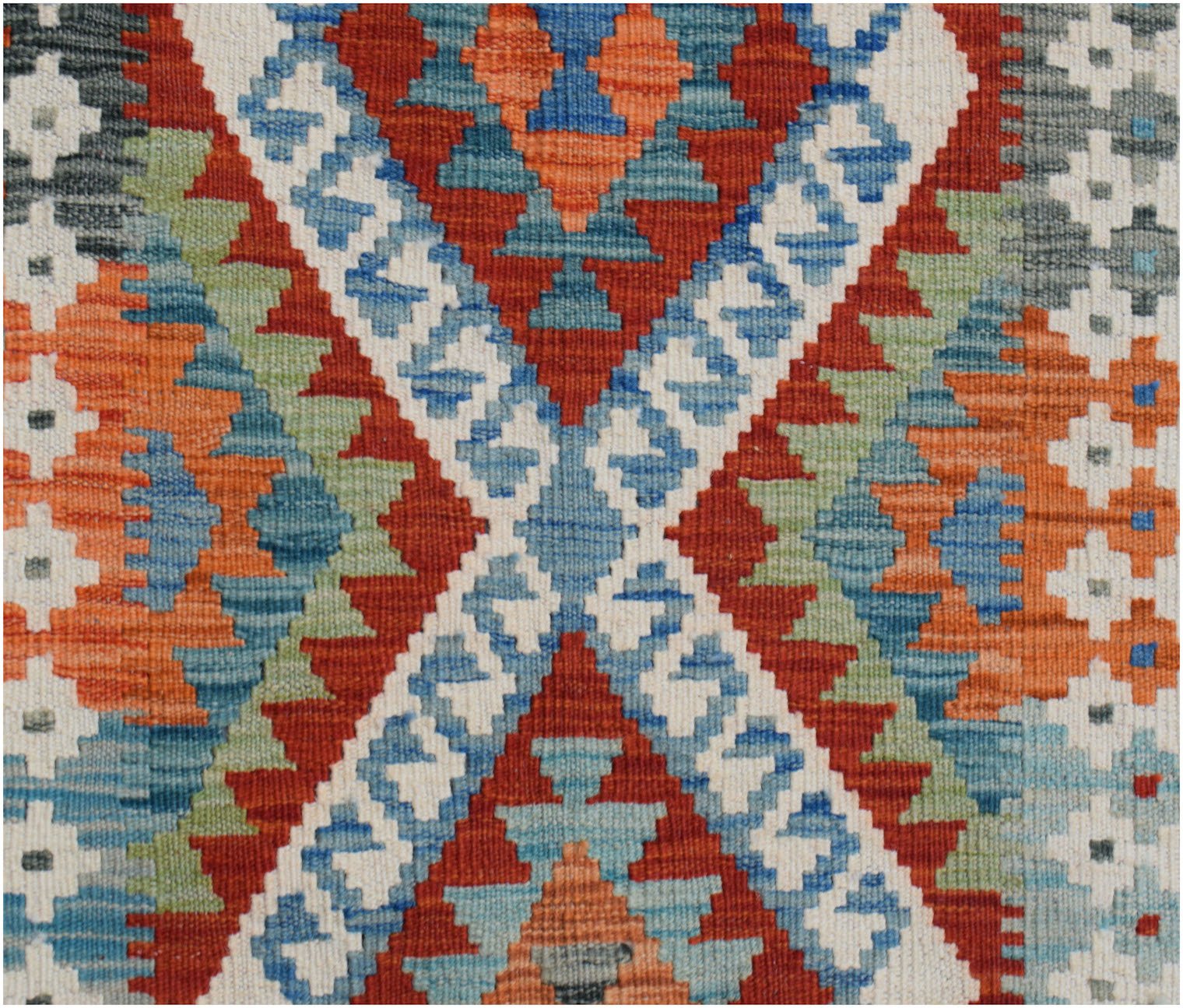 Handwoven Afghan Maimana kilim runner featuring a geometric pattern in red, blue, and green wool.