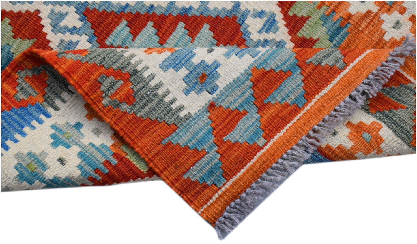 A handmade Afghan Maimana wool kilim runner featuring geometric patterns in orange and blue.