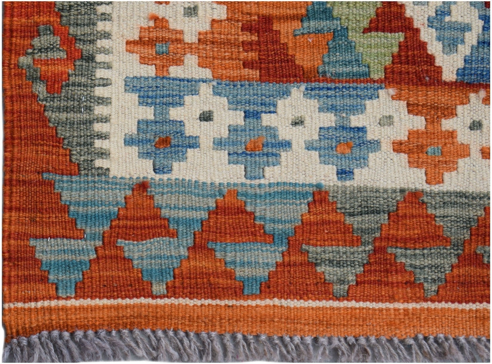 Handwoven Afghan Maimana wool runner featuring a geometric pattern in orange, blue, and grey.