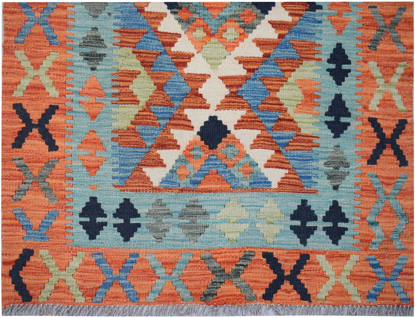 Handwoven Afghan Maimana kilim runner featuring a geometric pattern in orange, blue, and grey.