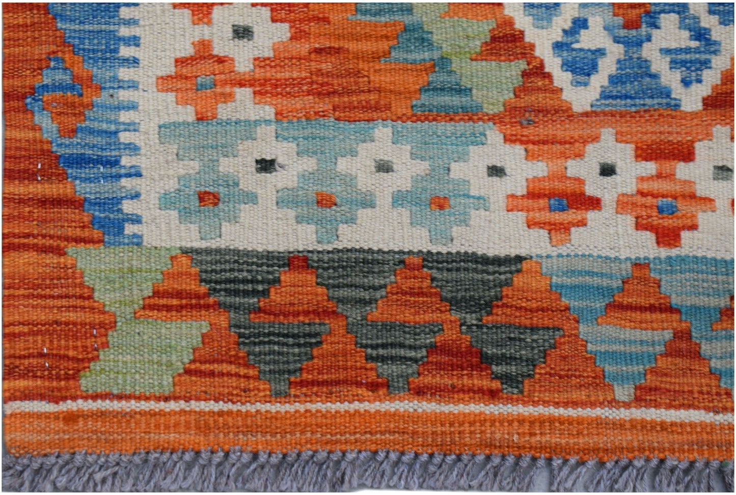 Handwoven Afghan Maimana kilim runner featuring geometric patterns in orange, blue, and grey.