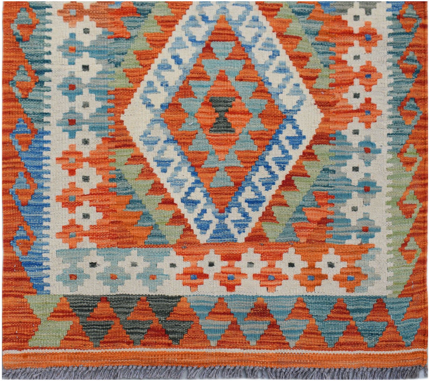 Handwoven Afghan Maimana wool runner featuring a geometric diamond pattern in orange and blue.