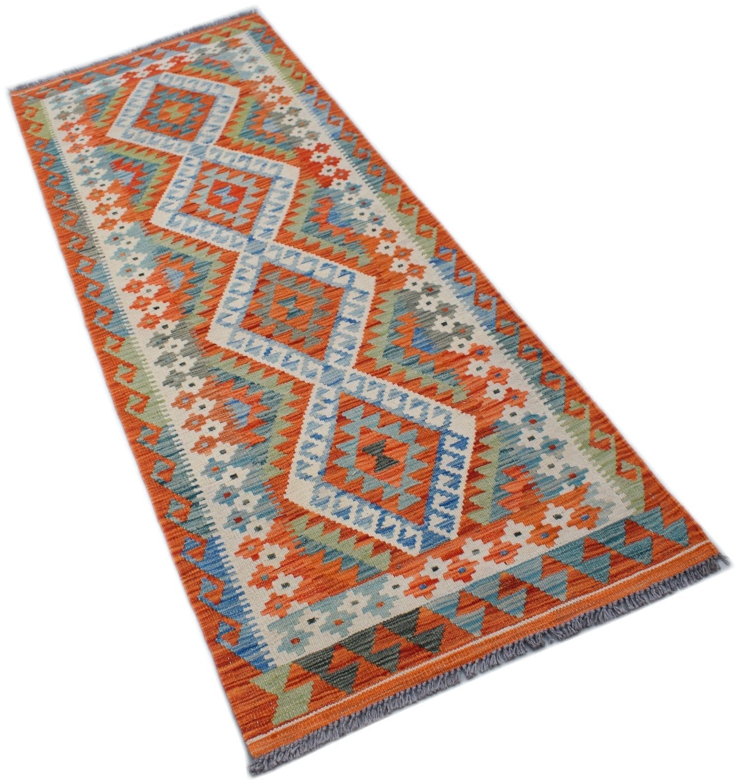 A handmade Afghan Maimana wool runner rug featuring a vibrant geometric diamond pattern.