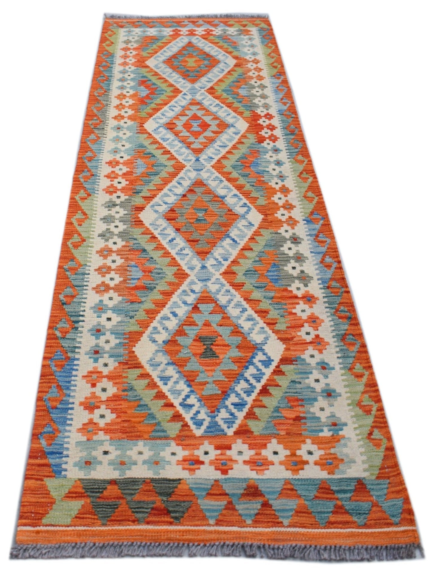 Handwoven Afghan Maimana wool runner rug featuring a geometric diamond pattern in orange and blue.