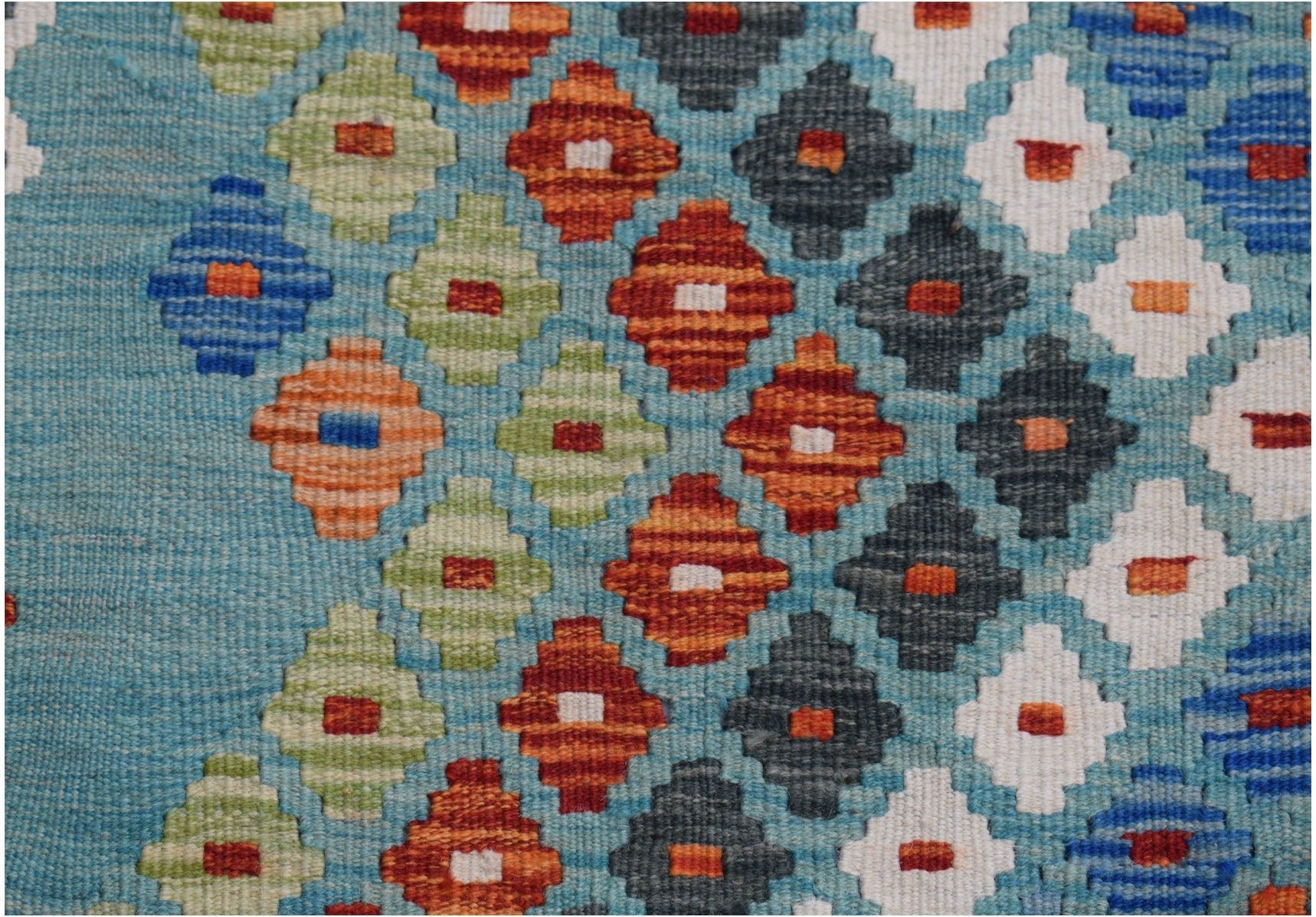 Handwoven Afghan Maimana kilim runner featuring a geometric diamond pattern in vibrant colors.