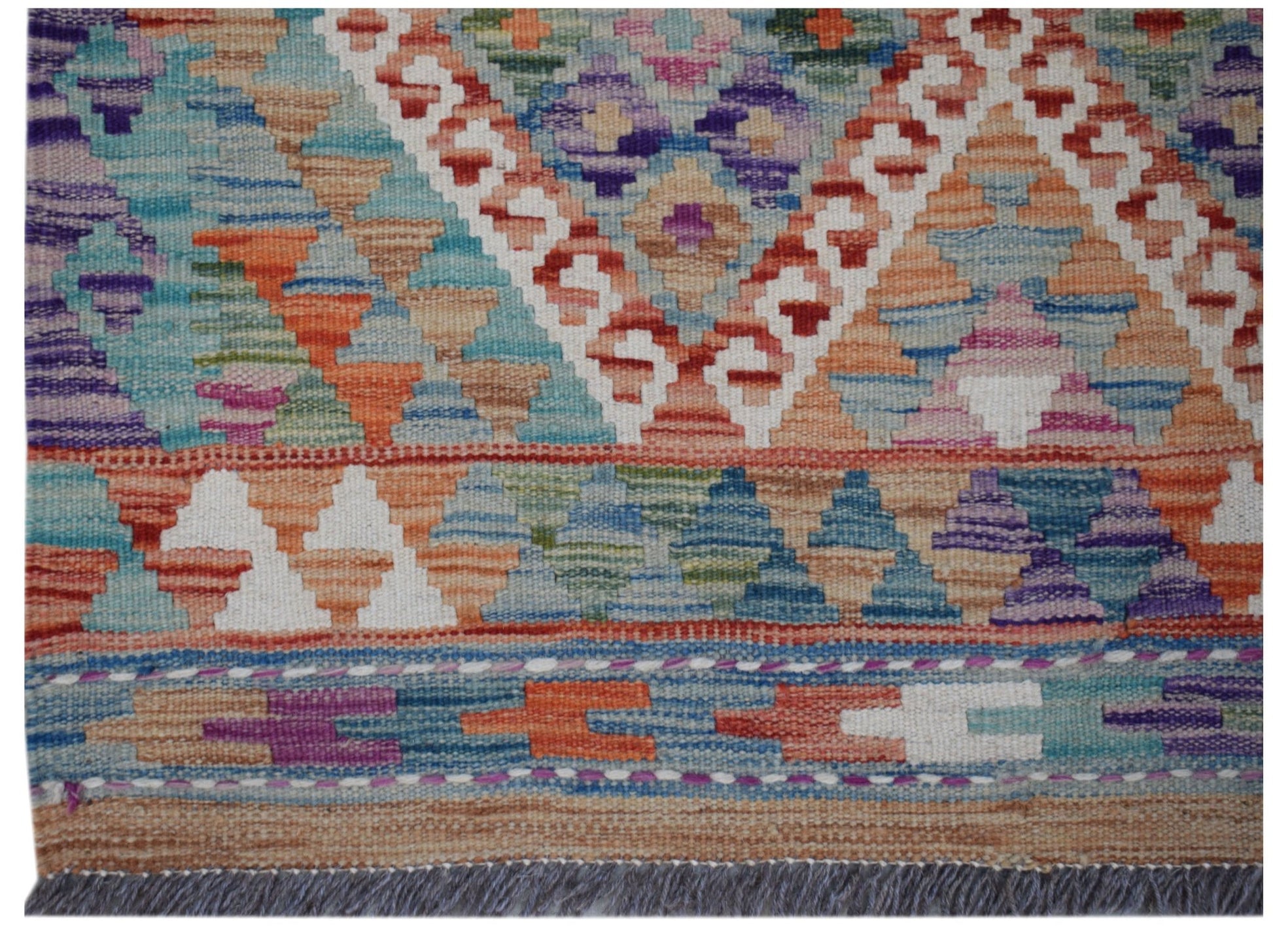 Handwoven Afghan Maimana wool runner featuring a colorful geometric pattern and fringed edges.