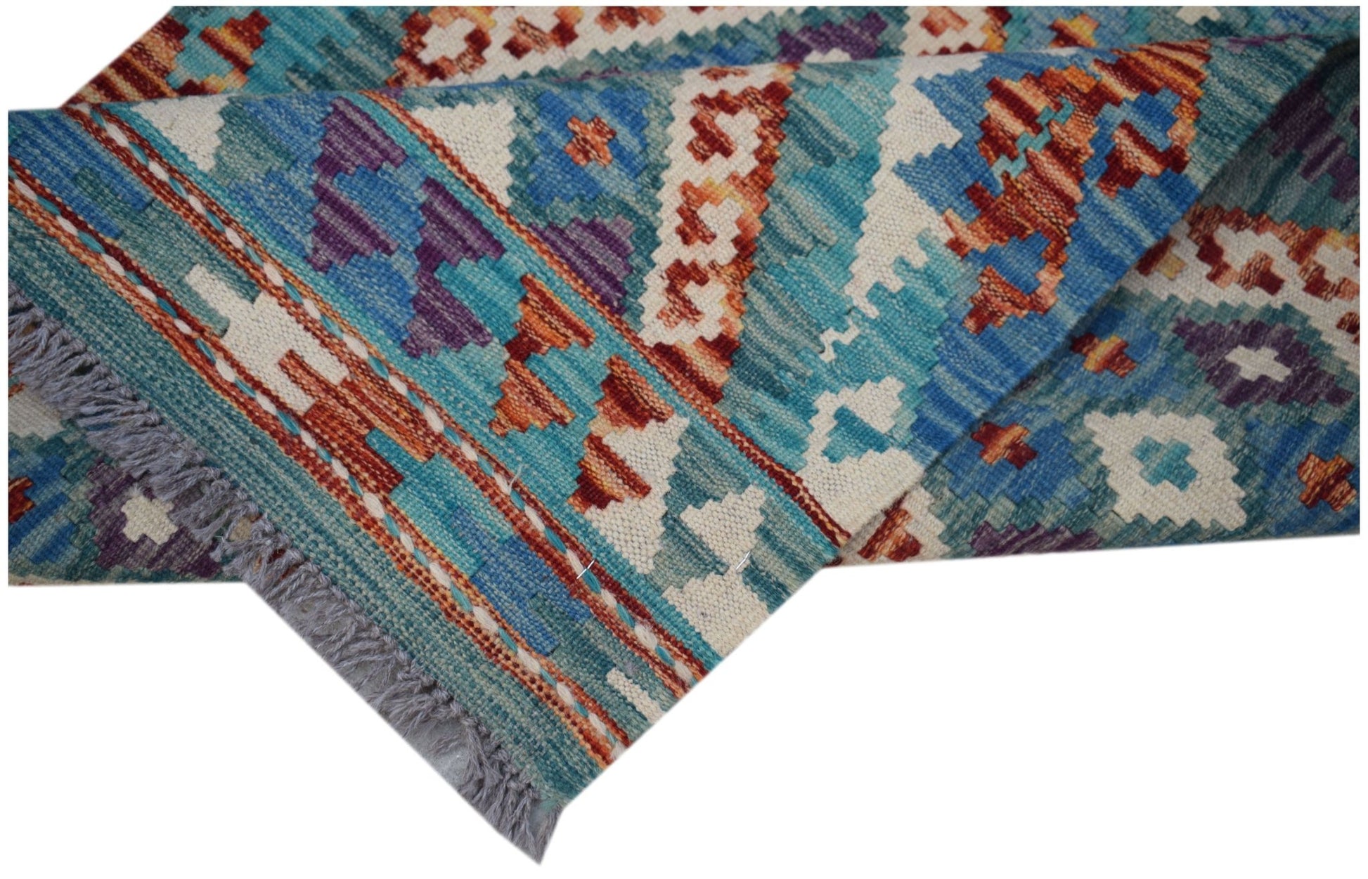 A handmade Afghan Maimana wool kilim runner featuring geometric patterns in blue and orange.