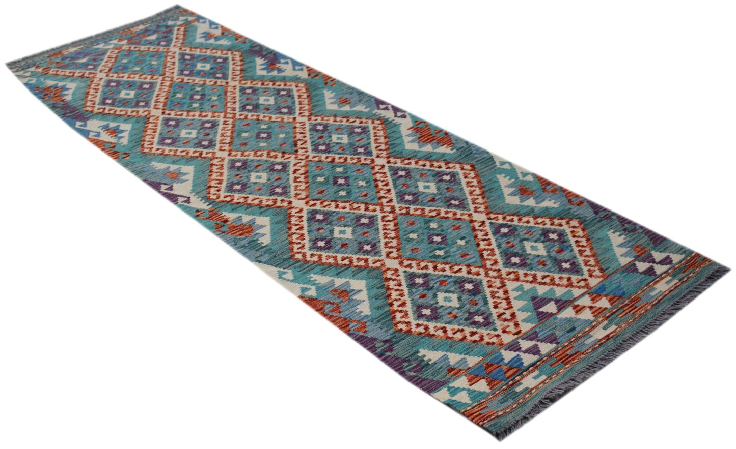 A handmade Afghan Maimana wool runner rug featuring a geometric diamond pattern in blue and orange.