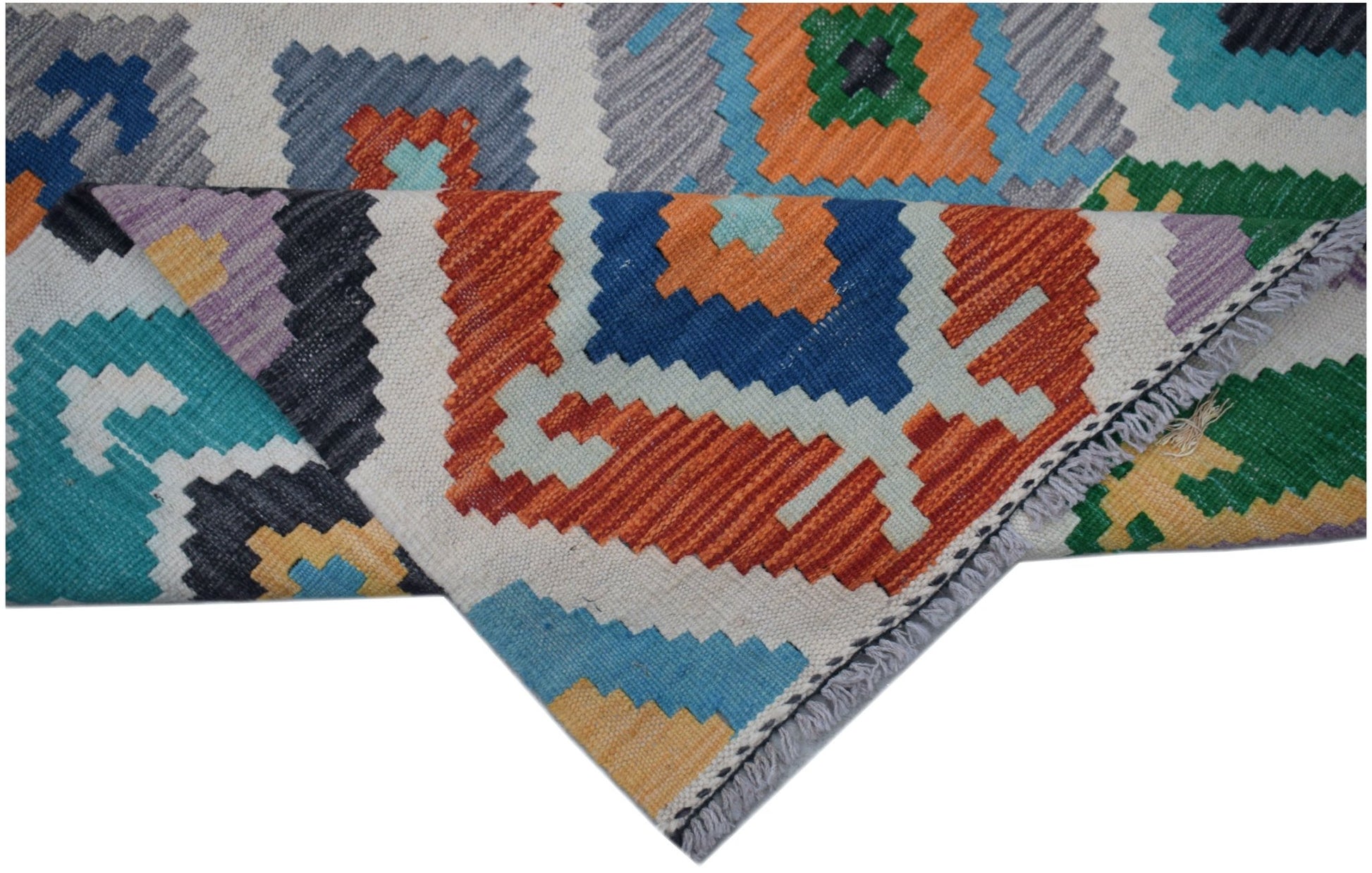 A handmade Afghan Maimana Kilim runner featuring a vibrant geometric pattern in wool.
