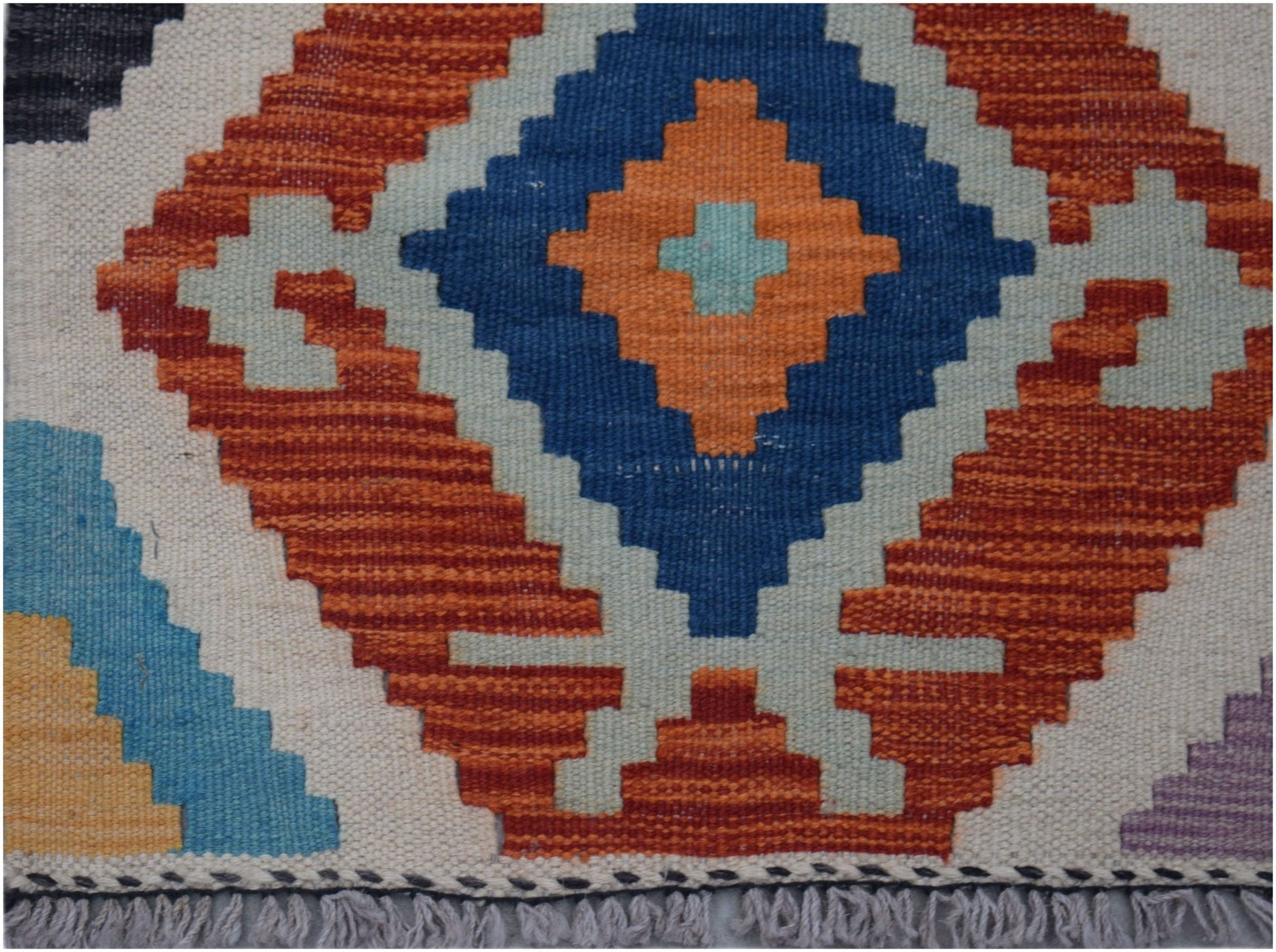 Handwoven Afghan Maimana kilim runner featuring a geometric diamond pattern in vibrant colors.