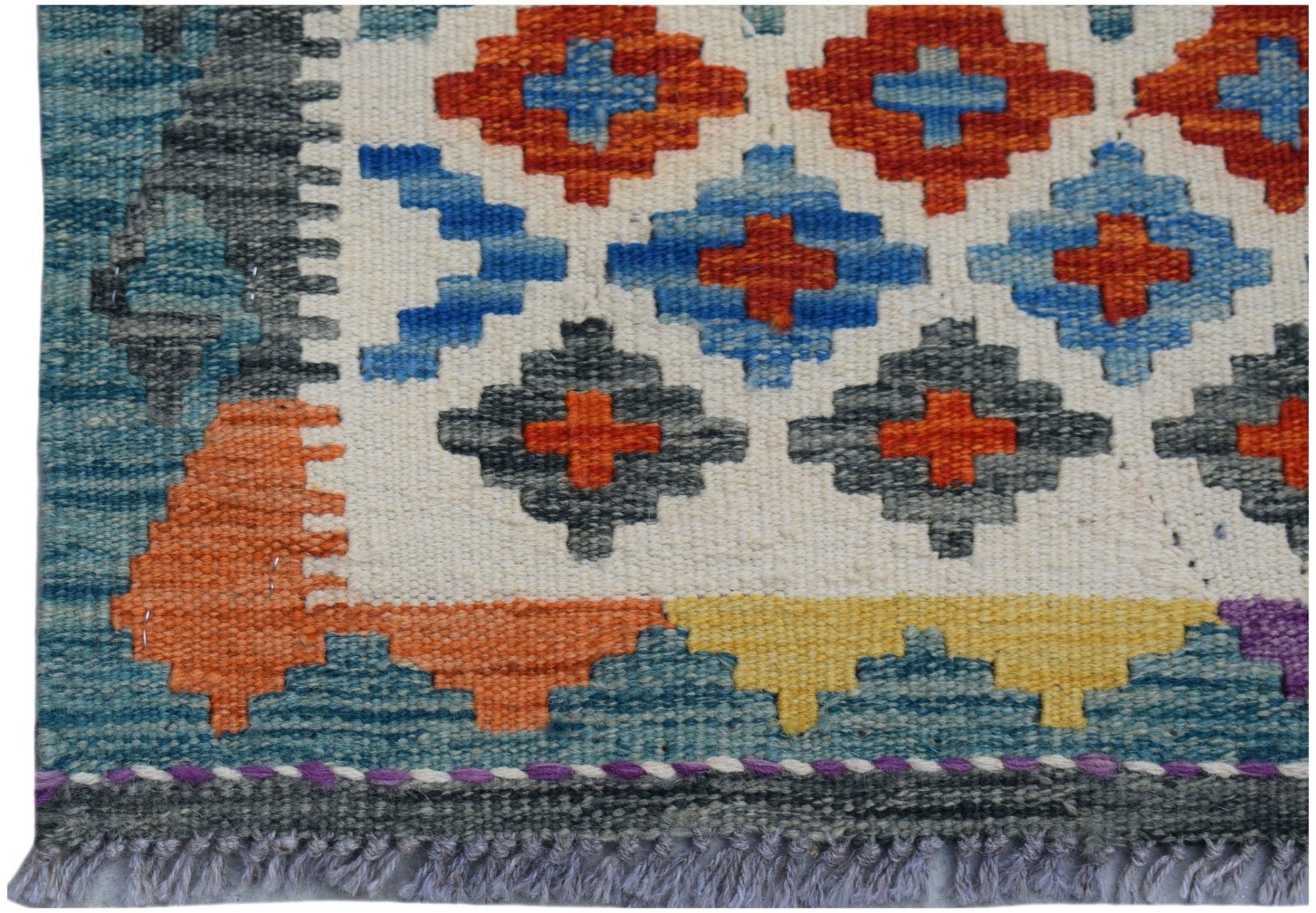 Handwoven Afghan Maimana wool runner featuring a geometric pattern in orange, blue, and grey.