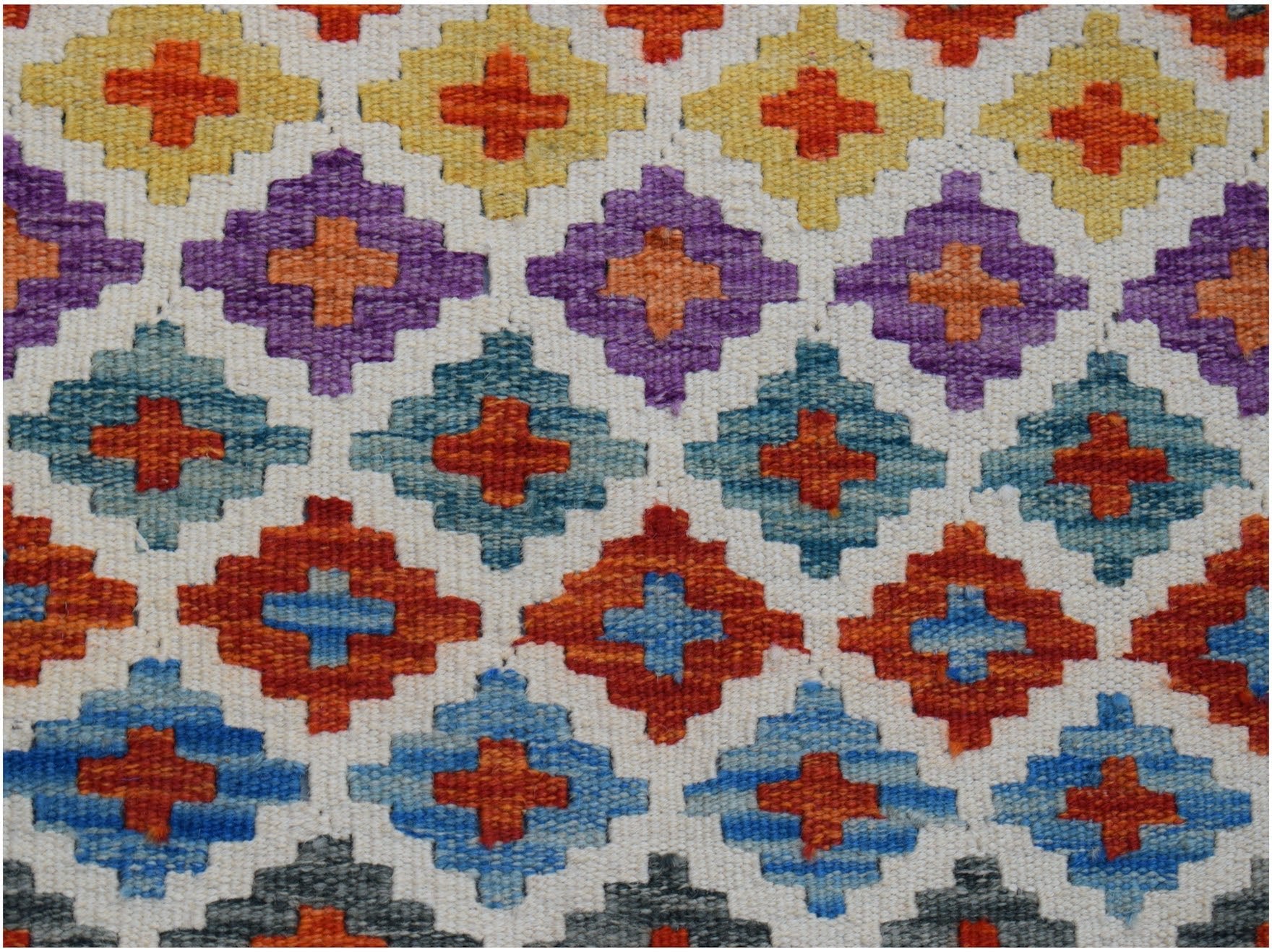 Handwoven Afghan Maimana kilim runner featuring a repeating geometric diamond pattern in wool.