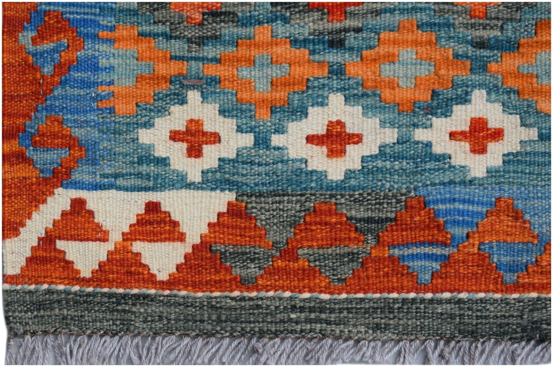Handwoven Afghan Maimana kilim runner featuring geometric patterns in orange, blue, and white.