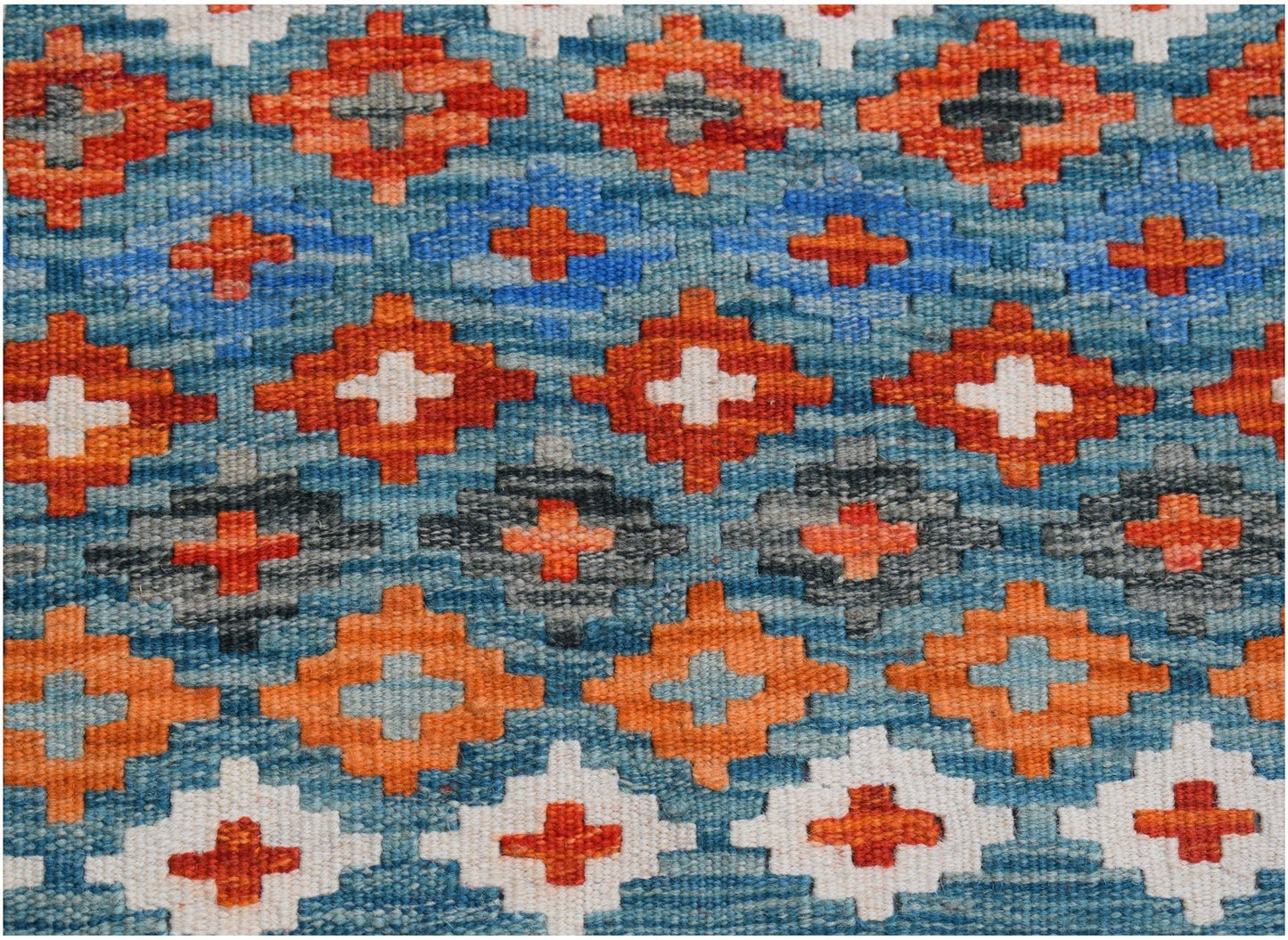 Handwoven Afghan Maimana kilim runner featuring a geometric pattern of orange, blue, and white.