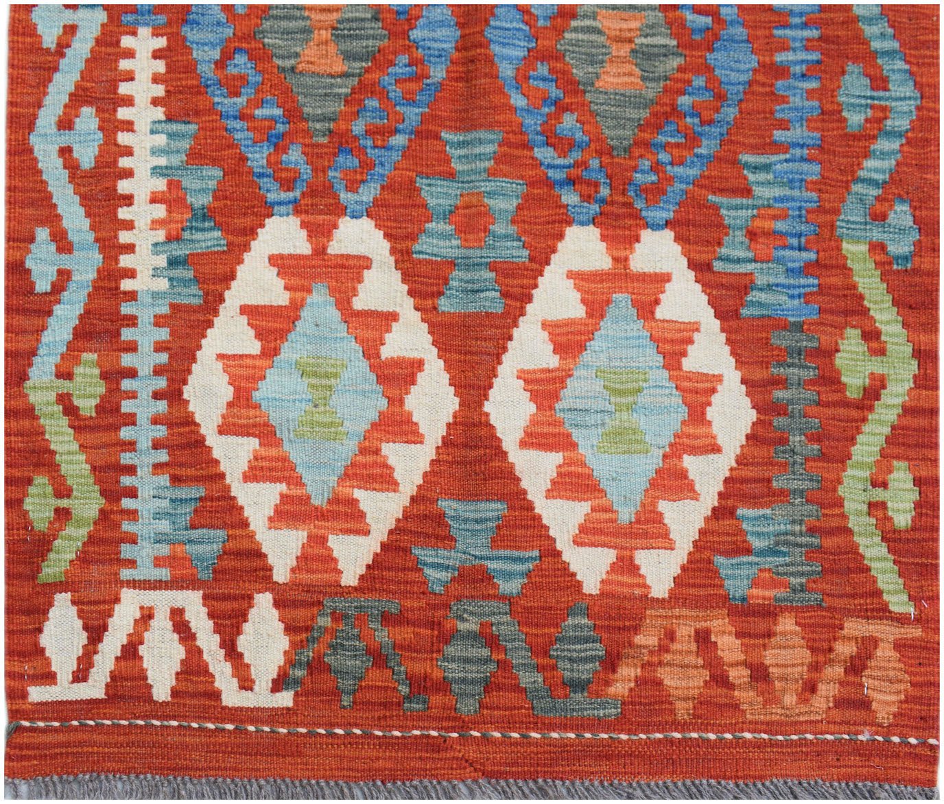 Handwoven Afghan Maimana wool runner featuring geometric diamond patterns in red, blue, and green.