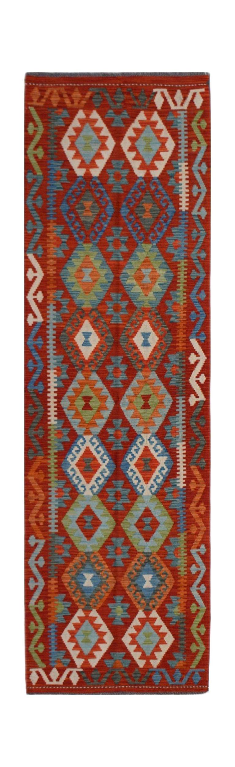 Handwoven Afghan Maimana wool runner featuring a vibrant red background and geometric patterns.