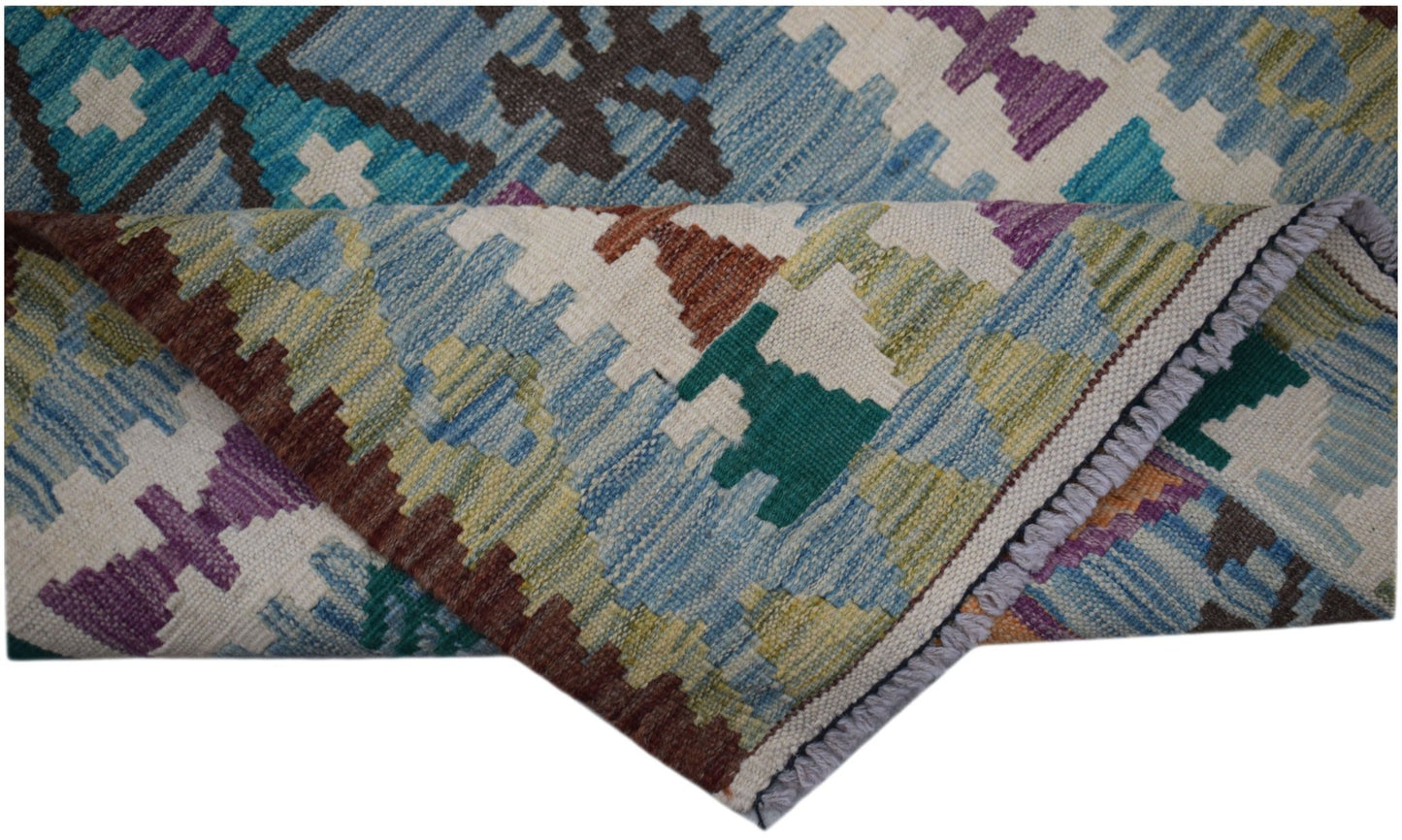 A handwoven Afghan Maimana wool kilim runner featuring a colorful geometric pattern.