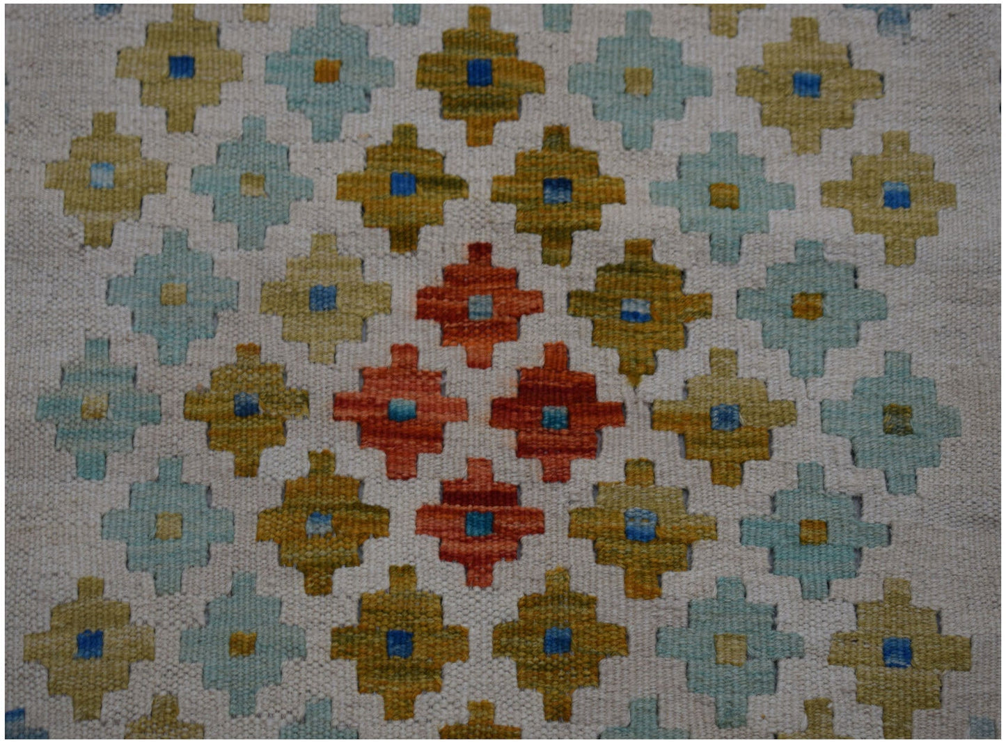 Handwoven Afghan Maimana wool kilim runner featuring a repeating geometric pattern in warm tones.