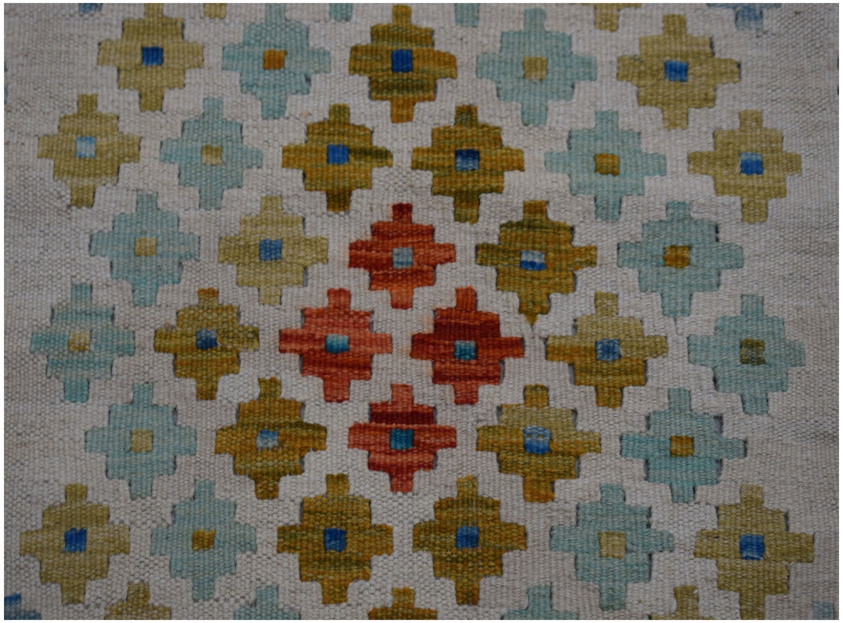 Handwoven Afghan Maimana wool kilim runner featuring a repeating geometric pattern in warm tones.